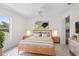 Bright bedroom with a wooden frame bed, side tables with lamps, a window, and closet at 4429 67Th E St, Bradenton, FL 34203