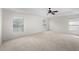 Bedroom featuring neutral carpet, ceiling fan, and multiple windows for ample natural light at 4429 67Th E St, Bradenton, FL 34203