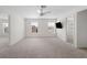 Spacious bedroom with neutral carpet, ceiling fan, and several windows for ample natural light at 4429 67Th E St, Bradenton, FL 34203