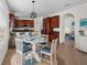 Bright dining room with a round table, modern light fixture, and kitchen view at 4429 67Th E St, Bradenton, FL 34203