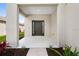 Inviting covered front porch with a modern dark brown door and updated landscaping at 4429 67Th E St, Bradenton, FL 34203