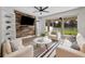 Bright living room with striped rug, wood accent wall, and sliding glass doors to backyard at 4429 67Th E St, Bradenton, FL 34203