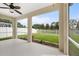 A screened-in patio featuring a ceiling fan and a view of the fenced backyard at 4429 67Th E St, Bradenton, FL 34203