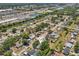 Neighborhood aerial shot highlighting a home with mature trees near a shopping center and green spaces at 4468 Maraldo Ave, North Port, FL 34287