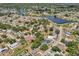 Picturesque aerial view of a neighborhood featuring a lake, well-maintained houses, and mature trees at 4468 Maraldo Ave, North Port, FL 34287