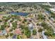 A beautiful aerial shot of a lakeside neighborhood with a mix of homes and lots of mature trees at 4468 Maraldo Ave, North Port, FL 34287