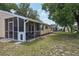 Spacious backyard featuring a screened patio and lush greenery at 4468 Maraldo Ave, North Port, FL 34287