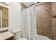Bathroom with modern tile, toilet, and shower with patterned curtain at 4468 Maraldo Ave, North Port, FL 34287