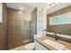Modern bathroom with tile walls, glass shower, granite sink, and a vanity mirror at 4468 Maraldo Ave, North Port, FL 34287