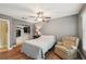 Comfortable bedroom featuring a ceiling fan, a closet, and a relaxing chair at 4468 Maraldo Ave, North Port, FL 34287