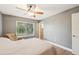 Bedroom featuring a ceiling fan, large window, wood floors, and natural lighting at 4468 Maraldo Ave, North Port, FL 34287