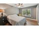 Bedroom with hardwood floors, large window, ceiling fan and a comfortable chair at 4468 Maraldo Ave, North Port, FL 34287