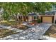 Charming single-story home featuring a well-maintained lawn, large shade trees, and neutral-toned exterior at 4468 Maraldo Ave, North Port, FL 34287