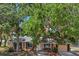 Charming single-story home featuring a well-maintained lawn, large shade trees, and neutral-toned exterior at 4468 Maraldo Ave, North Port, FL 34287