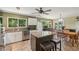Kitchen features an island, breakfast nook, stainless steel appliances, and tile flooring at 4468 Maraldo Ave, North Port, FL 34287