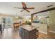 Open-concept kitchen with an island, stainless appliances, and adjacent living spaces at 4468 Maraldo Ave, North Port, FL 34287