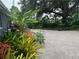 Expansive gravel backyard featuring abundant lush landscaping and a charming seating area at 4695 86Th N Ave, Pinellas Park, FL 33782
