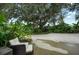 Secluded backyard featuring a seating area surrounded by tropical landscaping, offering a private retreat at 4695 86Th N Ave, Pinellas Park, FL 33782