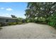 Spacious backyard features gravel, lush landscaping, and a charming patio area, perfect for outdoor relaxation at 4695 86Th N Ave, Pinellas Park, FL 33782