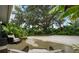 Charming backyard seating area with lush tropical landscaping and a view of mature trees at 4695 86Th N Ave, Pinellas Park, FL 33782