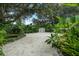 Spacious backyard featuring lush tropical landscaping and a storage shed at 4695 86Th N Ave, Pinellas Park, FL 33782