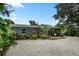 Back exterior of home with a small patio, and lush landscaping providing privacy at 4695 86Th N Ave, Pinellas Park, FL 33782