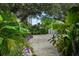 Beautifully landscaped backyard featuring a gravel path leading to a storage shed at 4695 86Th N Ave, Pinellas Park, FL 33782