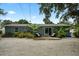 Landscaped backyard featuring an outdoor seating area, complemented by lush landscaping providing privacy at 4695 86Th N Ave, Pinellas Park, FL 33782