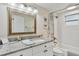 Bright bathroom with white cabinets, granite countertops, modern fixtures, and decorative accents at 4695 86Th N Ave, Pinellas Park, FL 33782