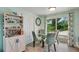 Dining area features a table with four chairs and natural backyard views at 4695 86Th N Ave, Pinellas Park, FL 33782