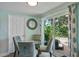 Cozy dining area with glass table and chairs next to sliding door to the backyard at 4695 86Th N Ave, Pinellas Park, FL 33782