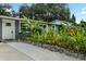 Charming home featuring lush landscaping, a quaint rock border, and a paved walkway at 4695 86Th N Ave, Pinellas Park, FL 33782