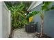 Exterior shot featuring the home's AC unit adjacent to lush landscaping and the home's gray exterior at 4695 86Th N Ave, Pinellas Park, FL 33782