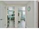 Hallway showing entry into the office and the Primary bedroom, with light walls and wood floors at 4695 86Th N Ave, Pinellas Park, FL 33782
