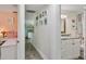Hallway connecting a bedroom, bathroom, and living space, with pictures adding a personal touch to the space at 4695 86Th N Ave, Pinellas Park, FL 33782