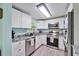 Modern kitchen featuring stainless steel appliances, granite countertops, and white cabinetry at 4695 86Th N Ave, Pinellas Park, FL 33782
