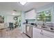 Kitchen features granite counters, stainless appliances, and adjacent dining area at 4695 86Th N Ave, Pinellas Park, FL 33782