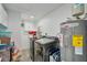 Functional laundry room with modern washer and dryer, plus a hot water heater, storage shelves and plenty of room at 4695 86Th N Ave, Pinellas Park, FL 33782