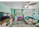 Comfortable living room with soft gray sofa, entertainment center, and a bright window allowing ample natural light at 4695 86Th N Ave, Pinellas Park, FL 33782