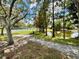 Beautiful view of a community park featuring a path, basketball court, and scenic pond at 4695 86Th N Ave, Pinellas Park, FL 33782