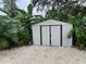 Outdoor shed with ample storage space, surrounded by lush tropical plants and a gravel yard at 4695 86Th N Ave, Pinellas Park, FL 33782