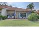 Charming back patio with lounge chairs, table and chairs, and a view of the lush green lawn at 5039 Kestral Park Dr # 67, Sarasota, FL 34231