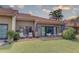 Charming back patio with lounge chairs, table and chairs, and a view of the lush green lawn at 5039 Kestral Park Dr # 67, Sarasota, FL 34231