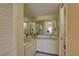 Well-lit bathroom with double sinks, vanity, and a large mirror, creating a comfortable and functional space at 5039 Kestral Park Dr # 67, Sarasota, FL 34231