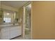 Well-lit bathroom featuring a vanity with a sink, a shower, and neutral-toned walls for a calming ambiance at 5039 Kestral Park Dr # 67, Sarasota, FL 34231