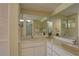 Bright bathroom with double sinks, a large mirror, and neutral color scheme, perfect for modern living at 5039 Kestral Park Dr # 67, Sarasota, FL 34231