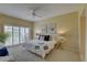Bright bedroom with sliding glass doors and a comfy bed that offers peaceful views of the outdoors at 5039 Kestral Park Dr # 67, Sarasota, FL 34231