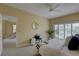 Bright bedroom with neutral paint, a ceiling fan, and sliding glass doors that let in lots of natural light at 5039 Kestral Park Dr # 67, Sarasota, FL 34231