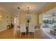 Open dining area with stylish table and chairs, modern light fixture, and serene view at 5039 Kestral Park Dr # 67, Sarasota, FL 34231