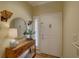 Inviting foyer featuring elegant decor, a decorative mirror, and stylish lighting at 5039 Kestral Park Dr # 67, Sarasota, FL 34231